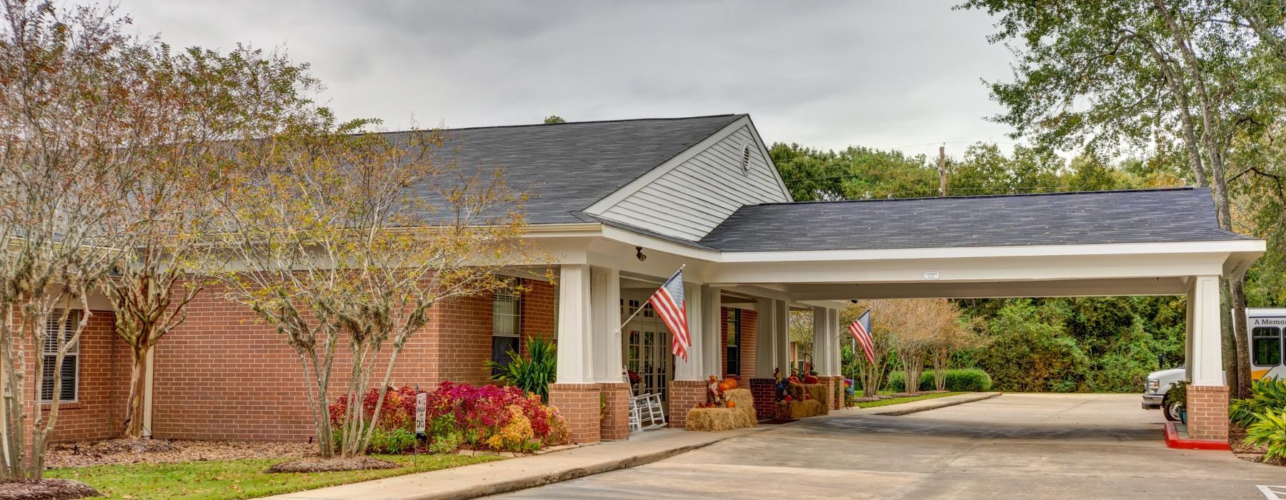 a clubhouse with a drive through porched entrance