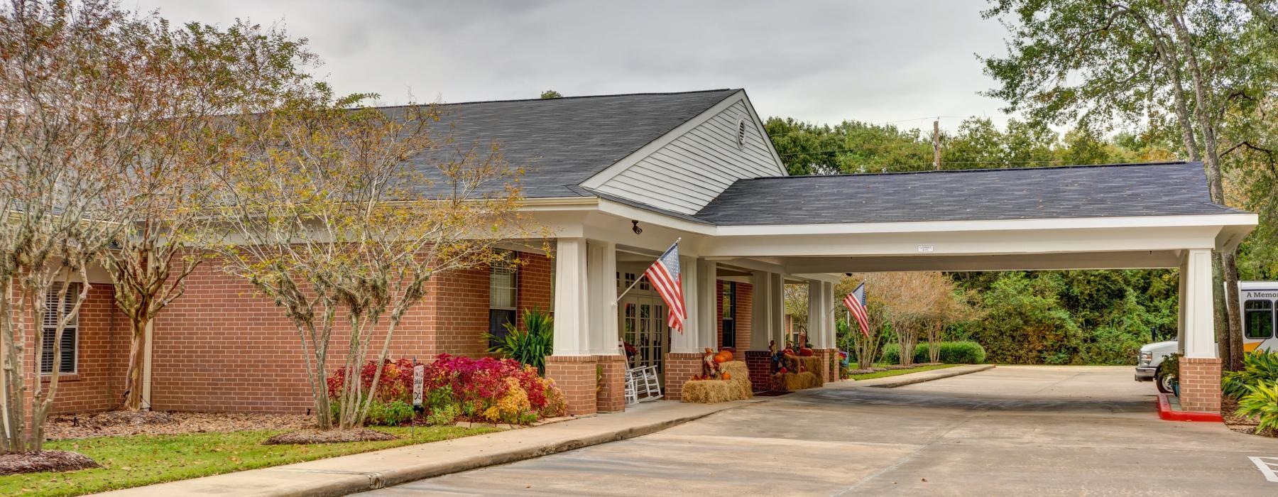 a clubhouse with a drive through porched entrance