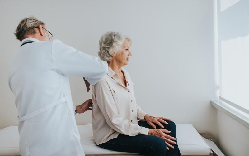 a doctor checking on an older woman