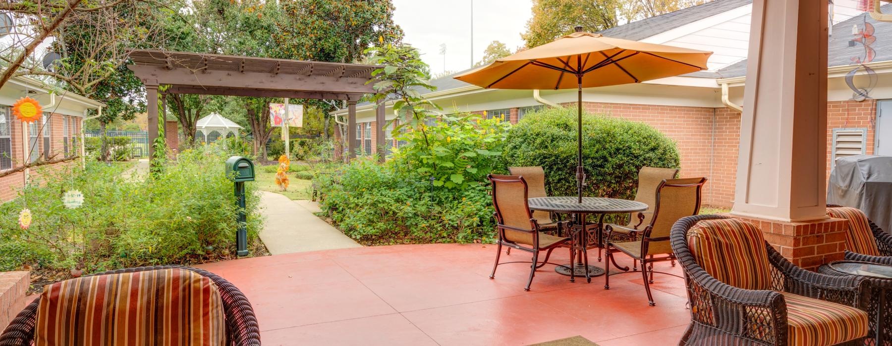 a patio with chairs and a table